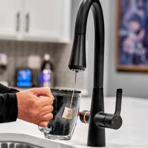 4N1 Instant Hot Water System with Leak Detector black faucet pouring a cup of tea