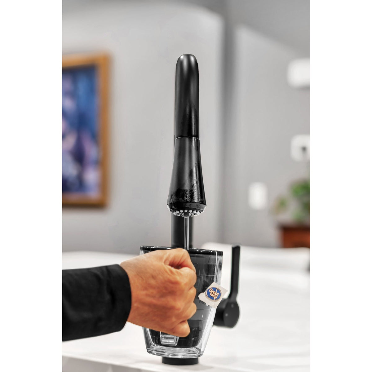 instant hot water faucet pouring hot water over tea cup